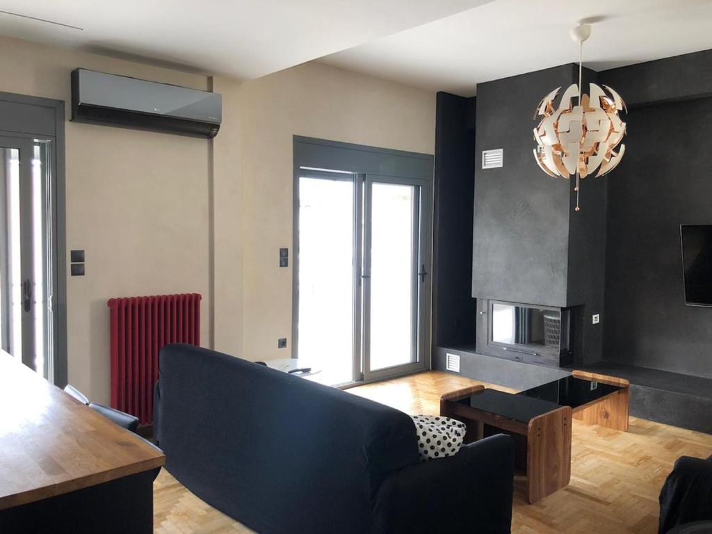 a living room with a couch and a fireplace at Luxurious apartment with big balconyBEST location in Athens