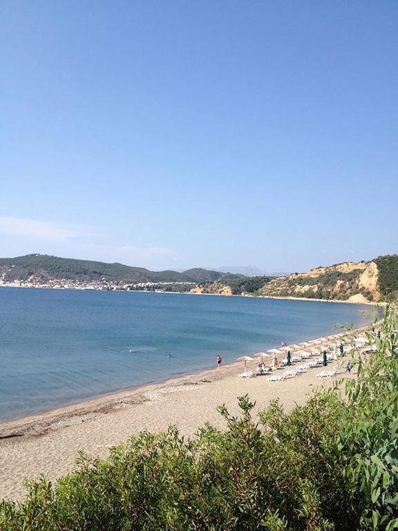 a beach with a group of people on the beach at The Olive Yard in Gythio