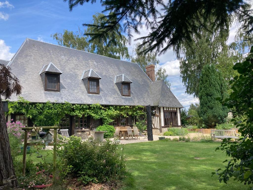 a house with a gray roof and a yard at cottage maison de campagne Normandie house Normandy in Berthouville