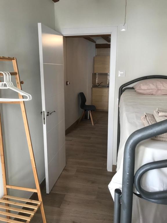 a dorm room with a bunk bed and a ladder at Centrally located two bedroom apartment in Perelló