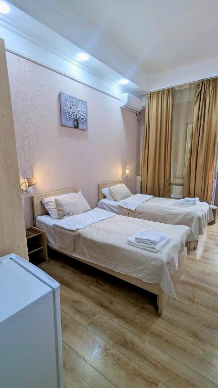 Postel nebo postele na pokoji v ubytování Dkd-bridge Hotel