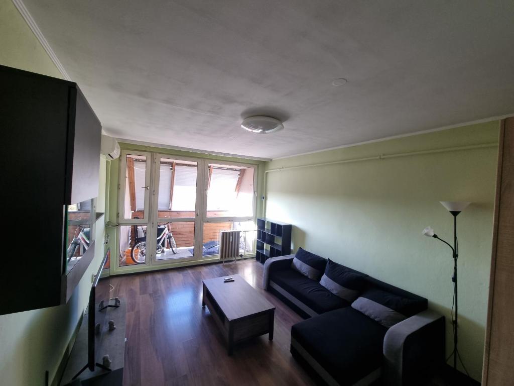 a living room with a couch and a table at Los Robles Avenue 2311 in Kaposvár