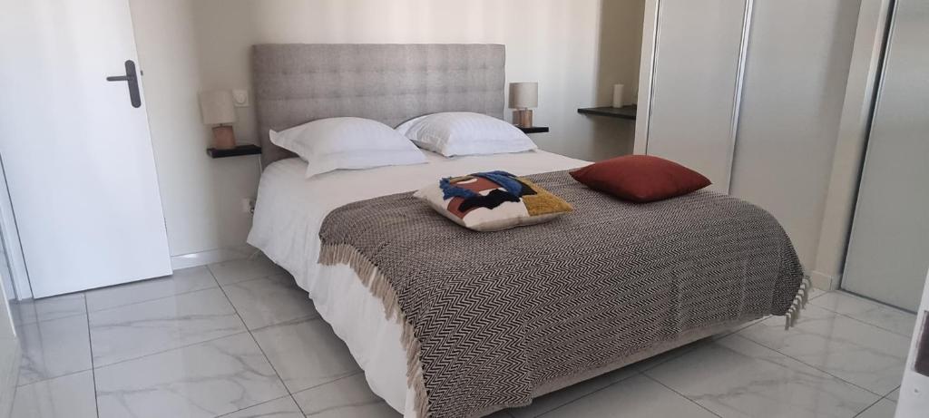 une chambre avec un grand lit dans une pièce dans l'établissement Le Phare, à Sète