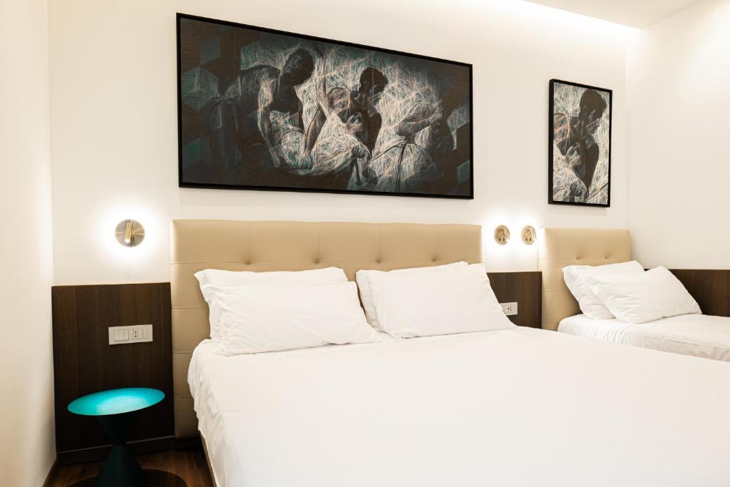 Postel nebo postele na pokoji v ubytování Hotel Vittoria