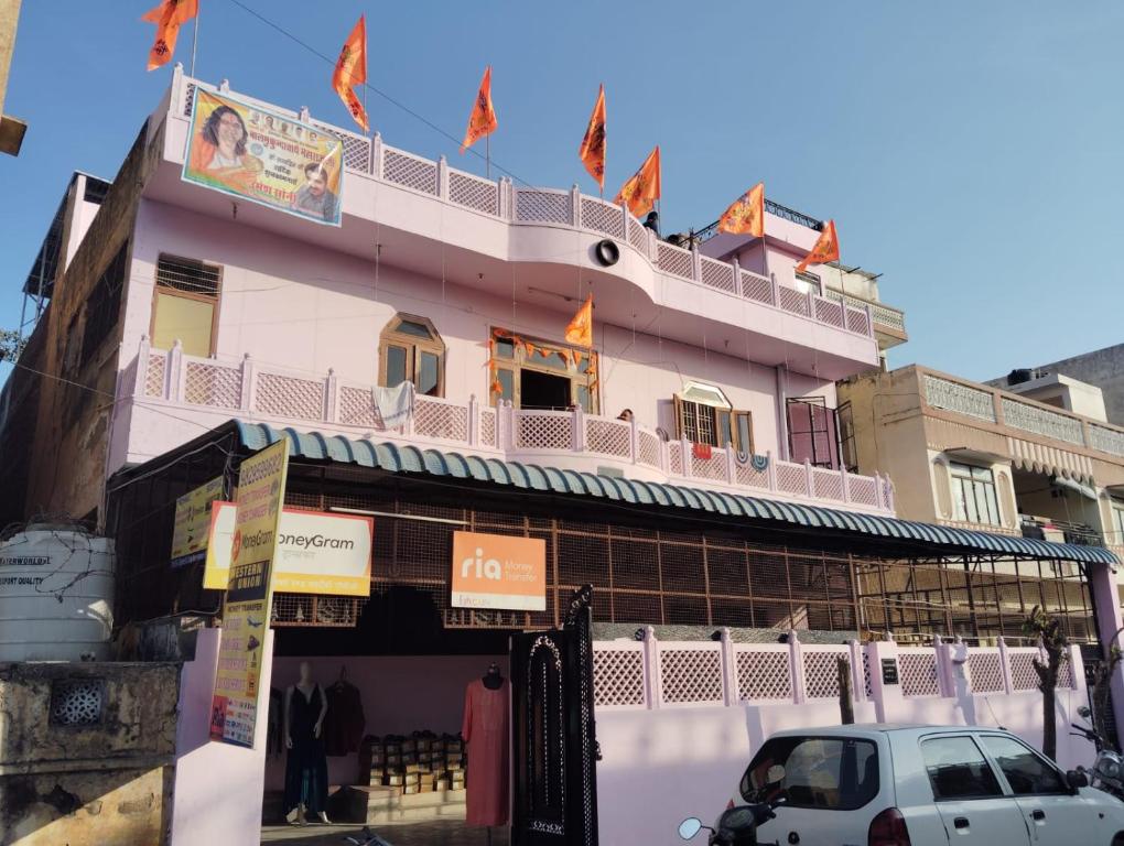 a pink building with a balcony on top of it at SHRI NIWAS GUEST HOUSe in Jaipur