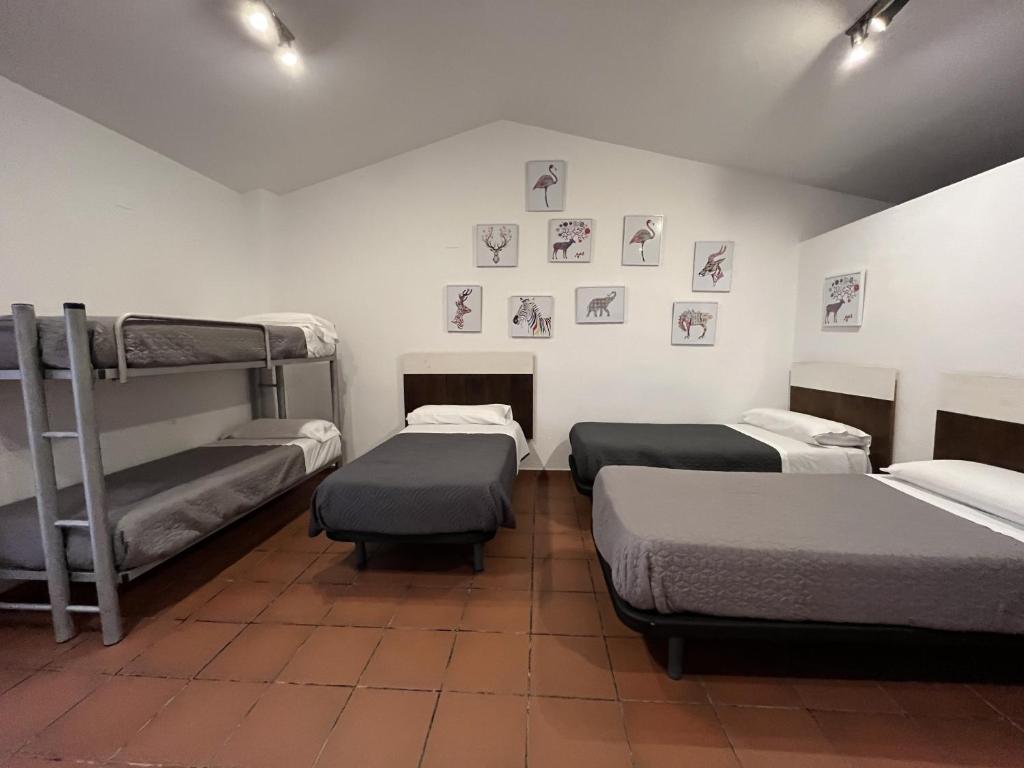 A bed or beds in a room at Masia Botargo 9 hab 8 baños piscina porche