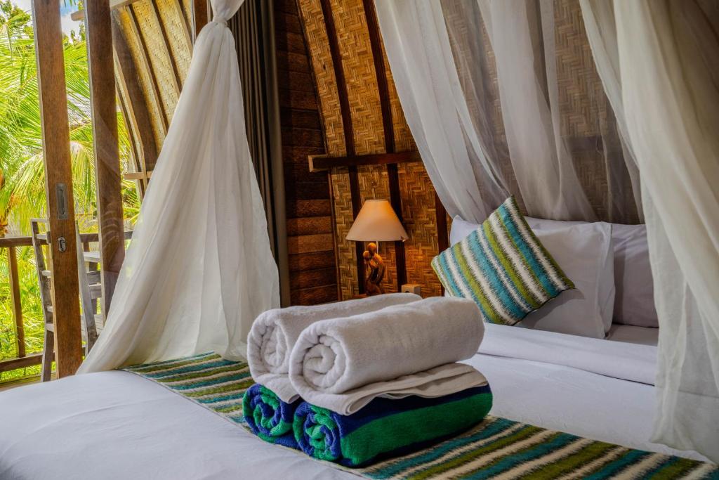 Postel nebo postele na pokoji v ubytování Lumbung Bukit Resort Uluwatu