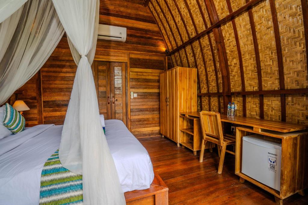 Postel nebo postele na pokoji v ubytování Lumbung Bukit Resort Uluwatu