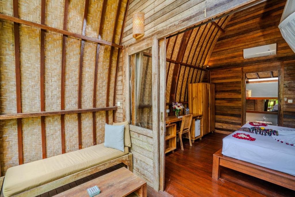 Postel nebo postele na pokoji v ubytování Lumbung Bukit Resort Uluwatu