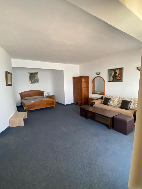 a living room with a bed and a couch at Hotel Noy in Varna City