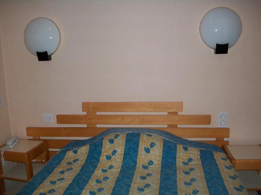 Postel nebo postele na pokoji v ubytování Hotel L'Aiglon