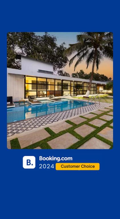 a picture of a building with a swimming pool at EKOSTAY - Hazelnut Villa in Alibaug