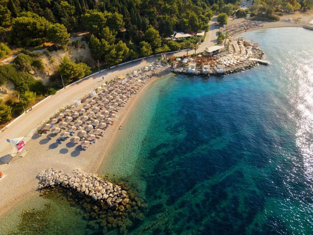 an aerial view of a beach with umbrellas and boats at Radisson Blu Resort & Spa in Split