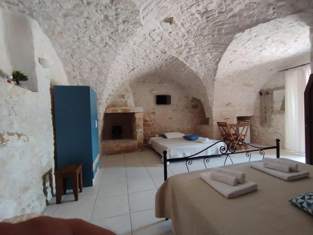 Postel nebo postele na pokoji v ubytování Il Trullo e la Pietra