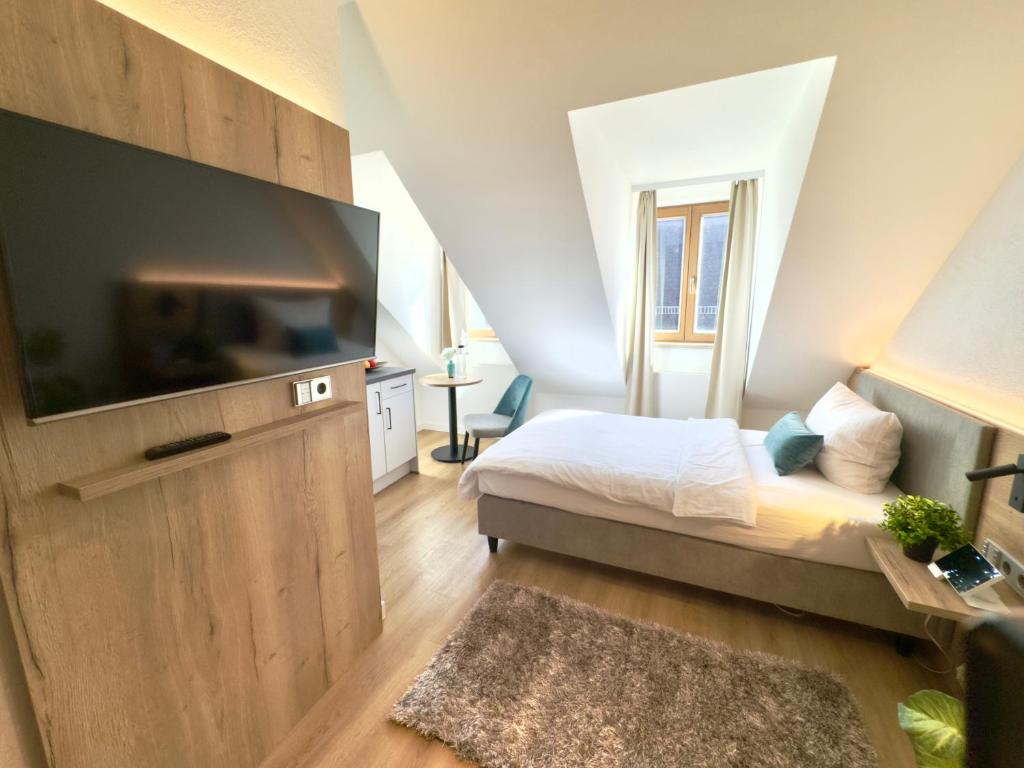 TV a/nebo společenská místnost v ubytování Living & Serviced Apartments by Blauer Wolf