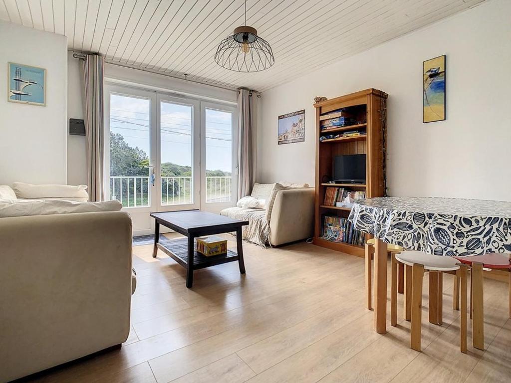 un salon avec un canapé et une table dans l'établissement Appartement 2 chambres proche mer - 1er étage, parking, cuisine équipée, TV et calme assuré - FR-1-236-77, à Stella-Plage