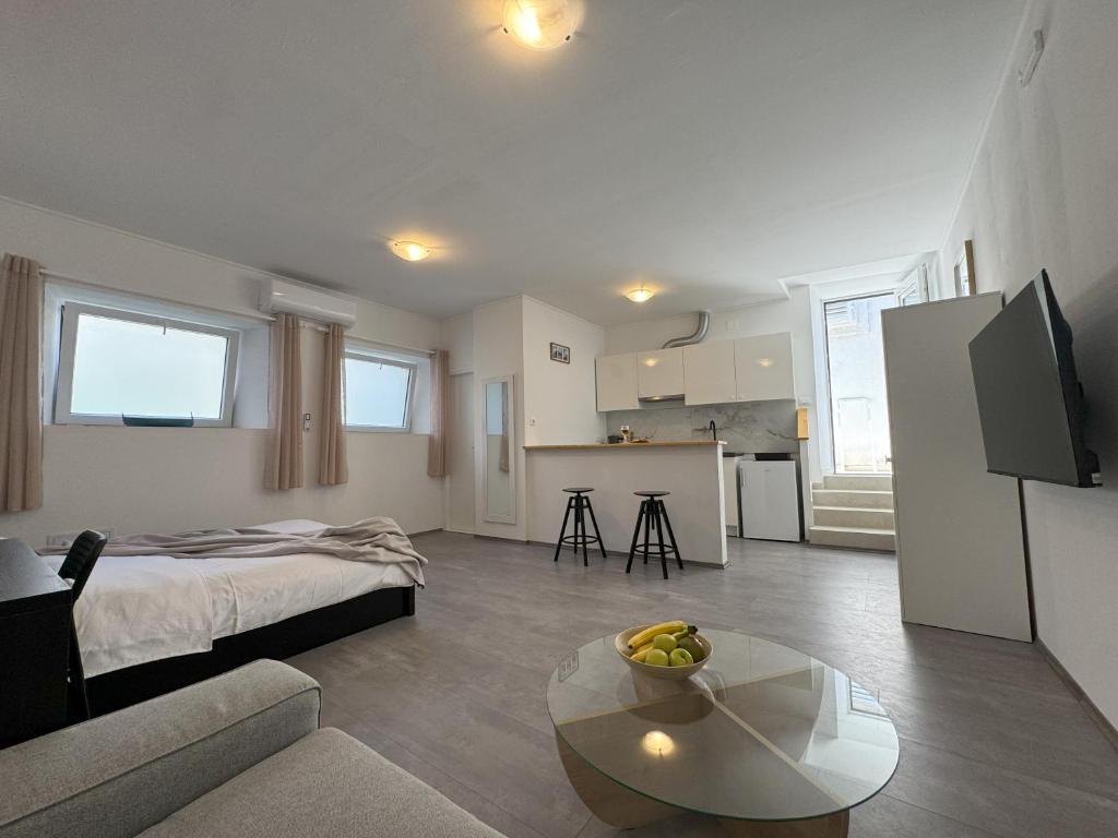 a living room with a bed and a table at Studio Rimac in Dubrovnik