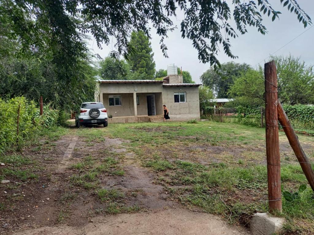 a car parked in front of a small house at Cabaña al pie de las Sierras in Santa María