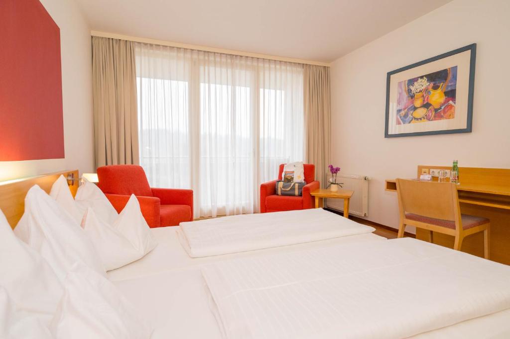 Ein Bett oder Betten in einem Zimmer der Unterkunft Allegria Resort Stegersbach - Allegria Hotel