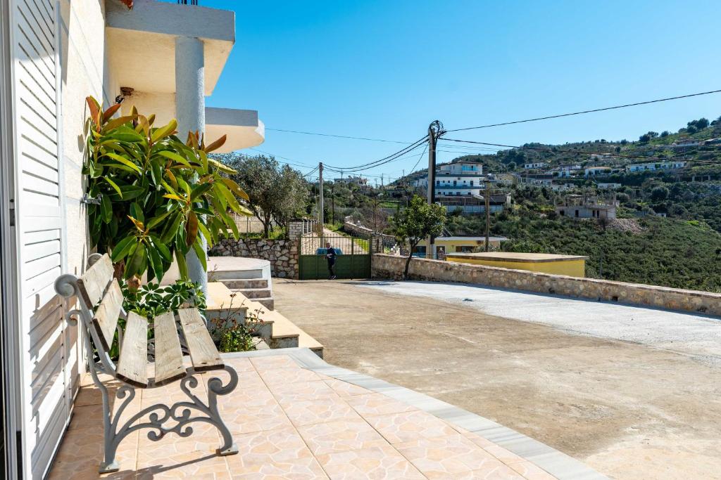 a bench sitting on the side of a house at Vila Celi in Sarandë