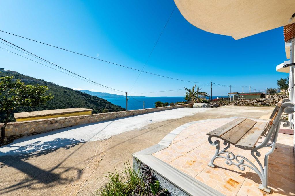 a wooden bench sitting on top of a patio at Vila Celi in Sarandë
