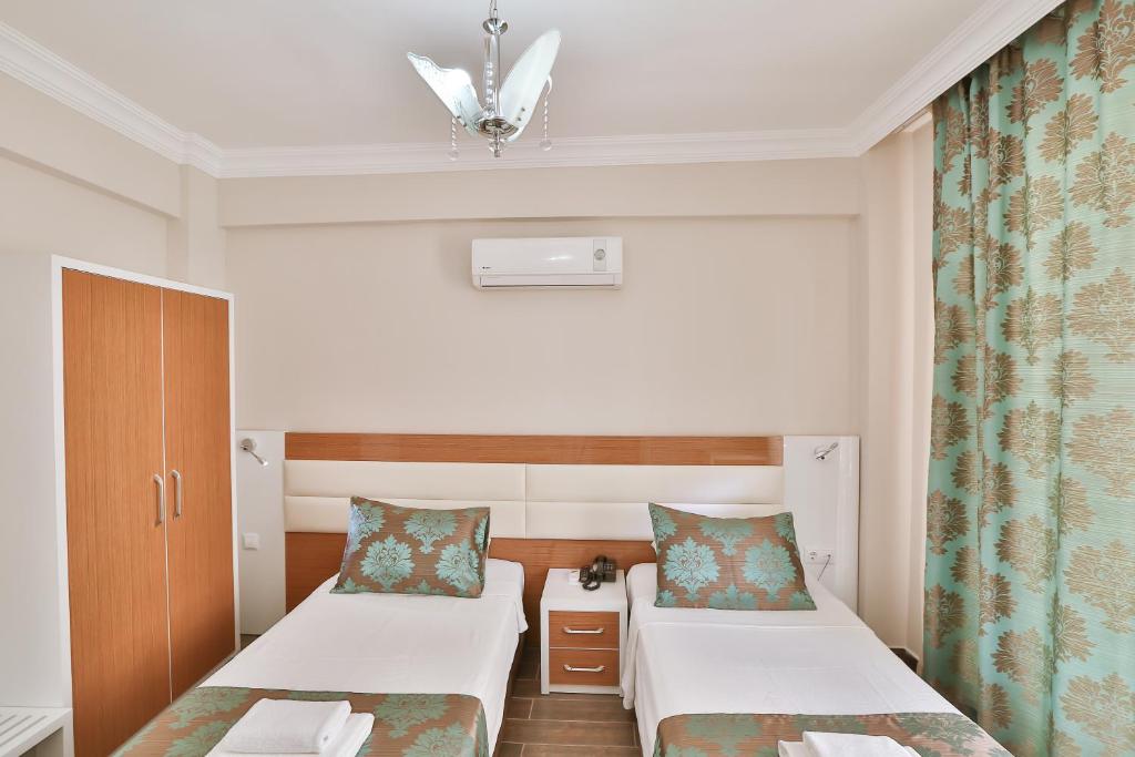 Кровать или кровати в номере Hotel Kayahan