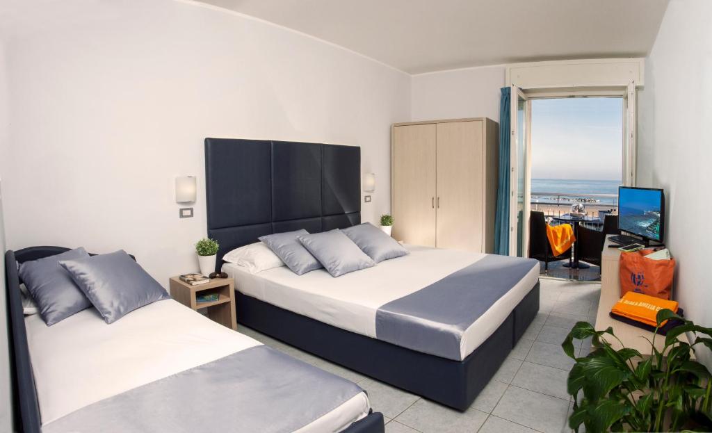 Postel nebo postele na pokoji v ubytování Baby Family Hotel Alda Amelia