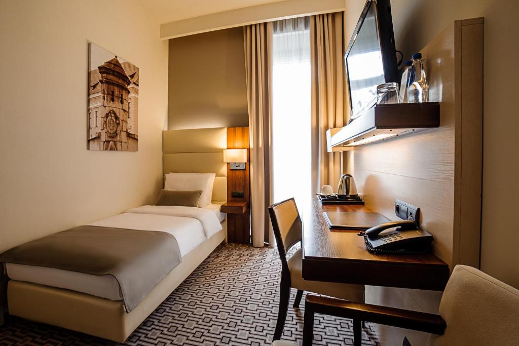 Postel nebo postele na pokoji v ubytování B&B HOTEL RZESZÓW CENTRUM