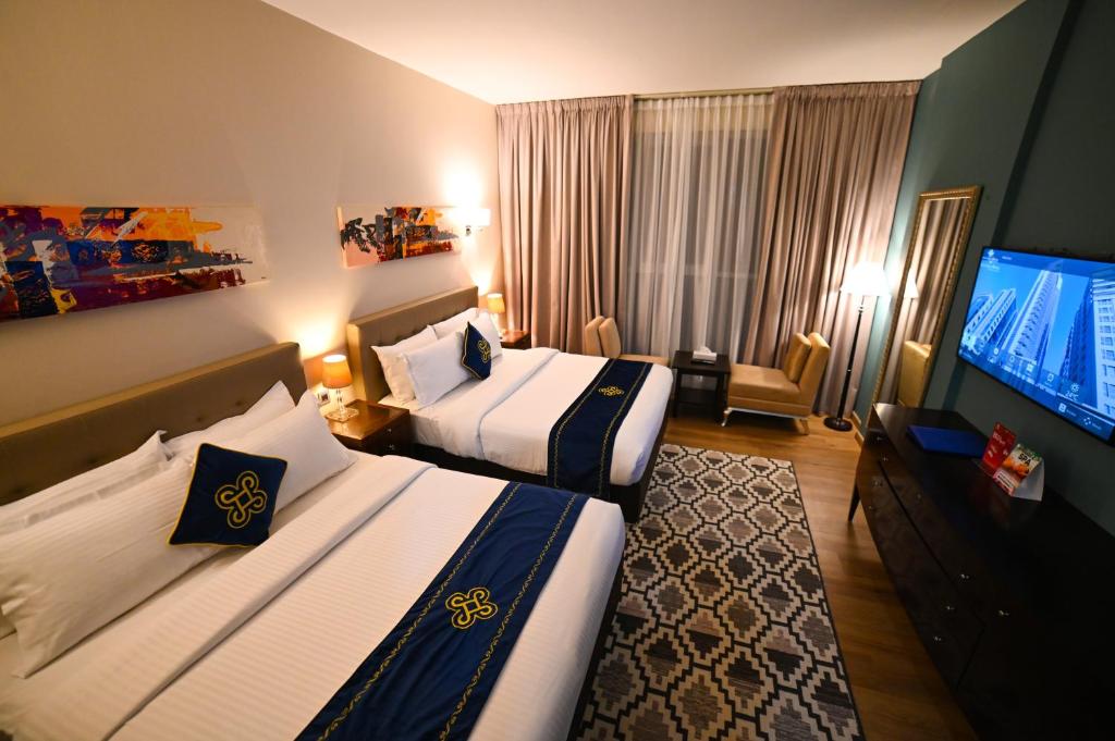 Postel nebo postele na pokoji v ubytování Seven Seas Hotel