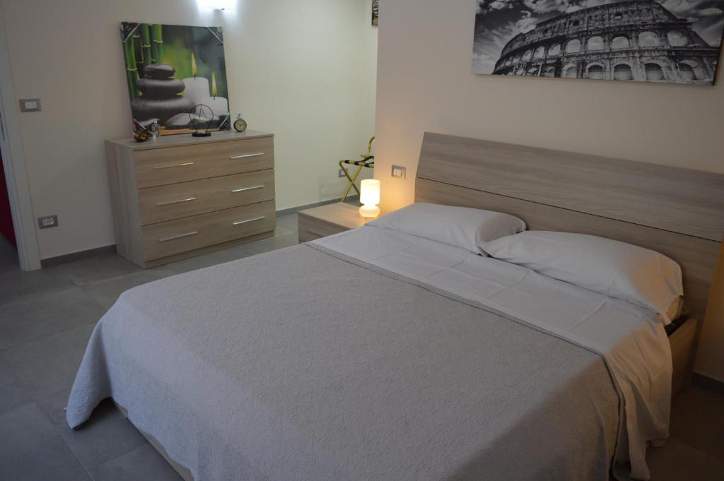 a bedroom with a large bed and a dresser at Bea&B in Rome