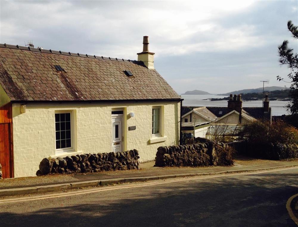 a white house on the side of a street at Primrose Cottage in Rockcliffe