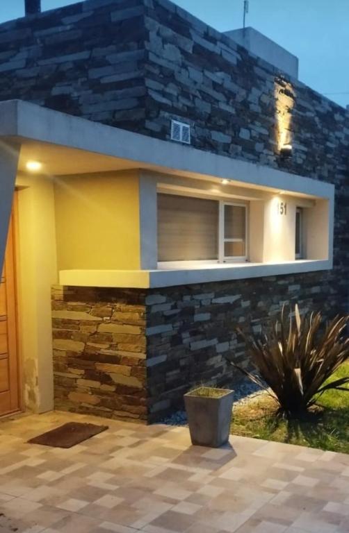 a house with a stone wall at Casa de mar in Miramar
