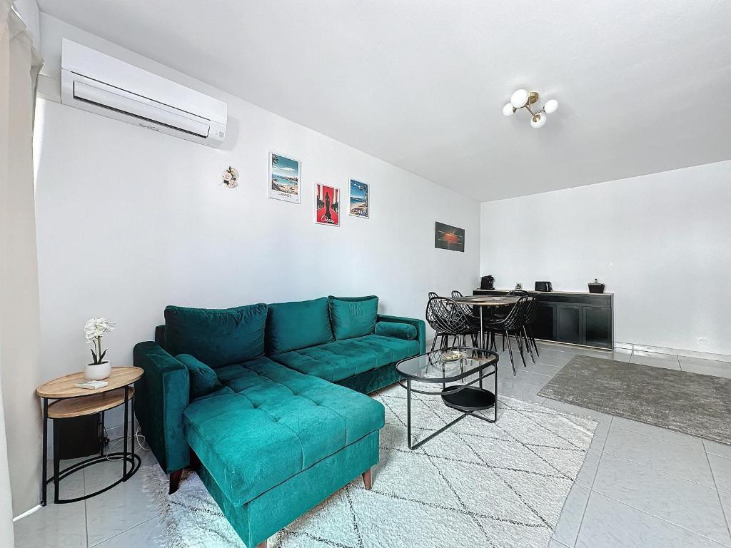 un salon avec un canapé vert et une table dans l'établissement Intuition 4pers 10min Palais, à Cannes
