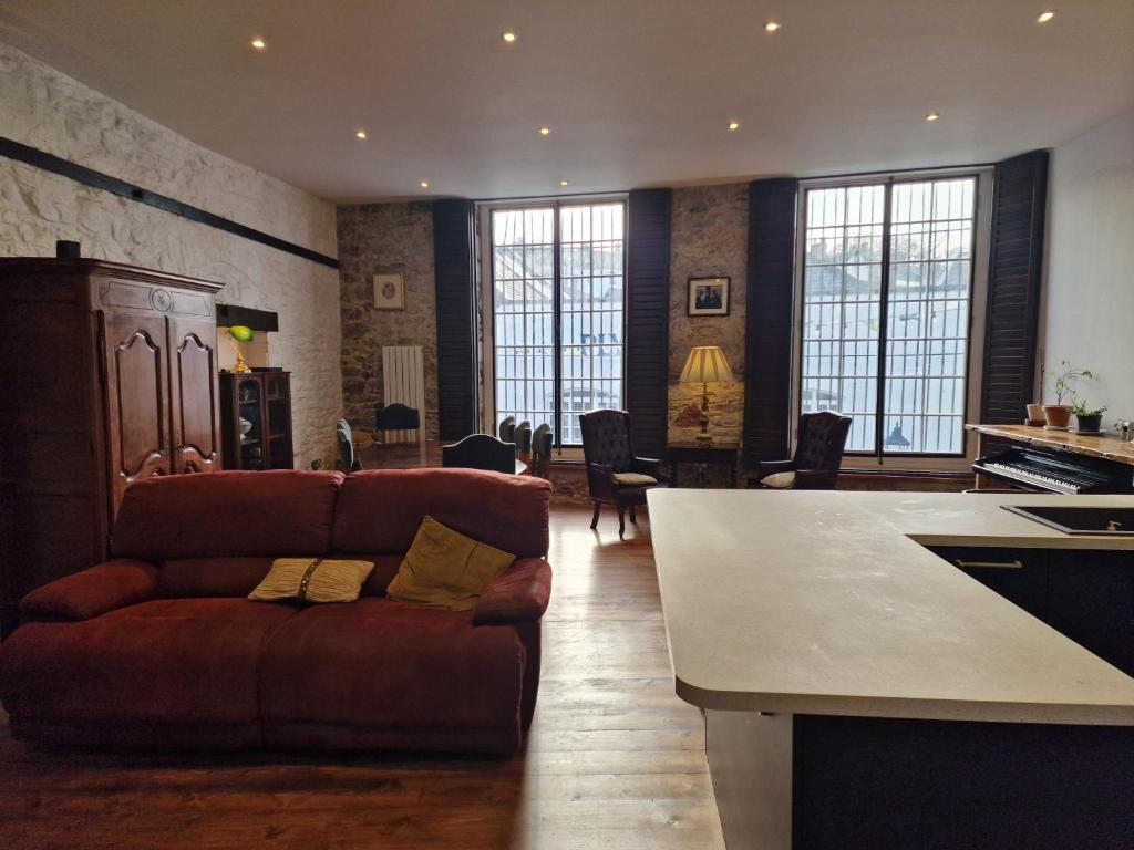 a living room with a couch and a kitchen at Luxury Barbican Apartment in Plymouth