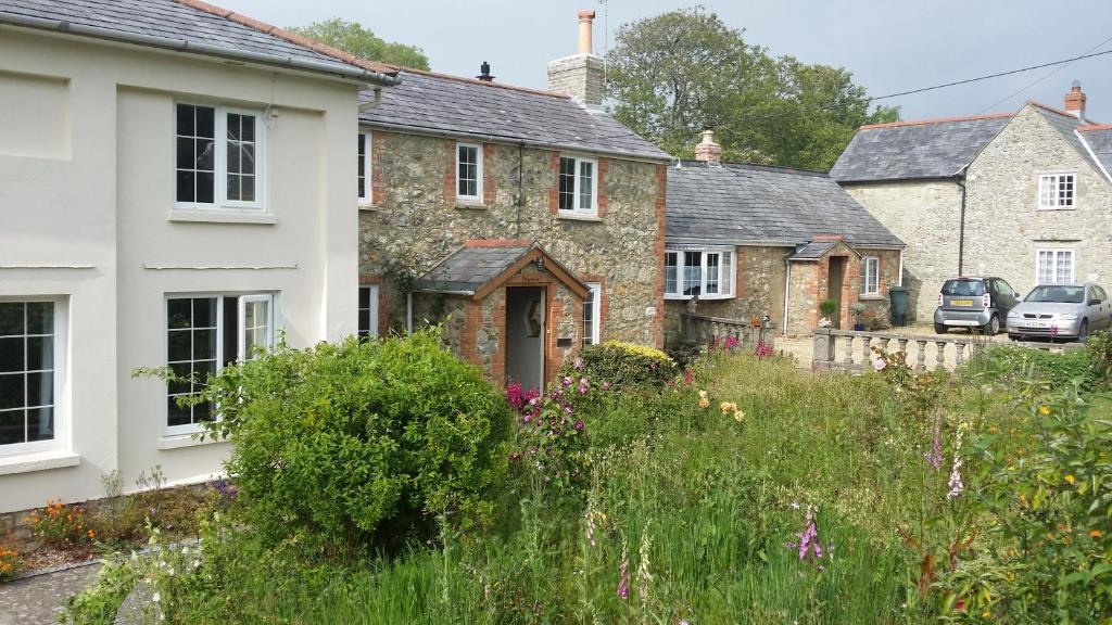 a row of houses in a village with a garden at Kingsmede Bed & Breakfast in Ventnor