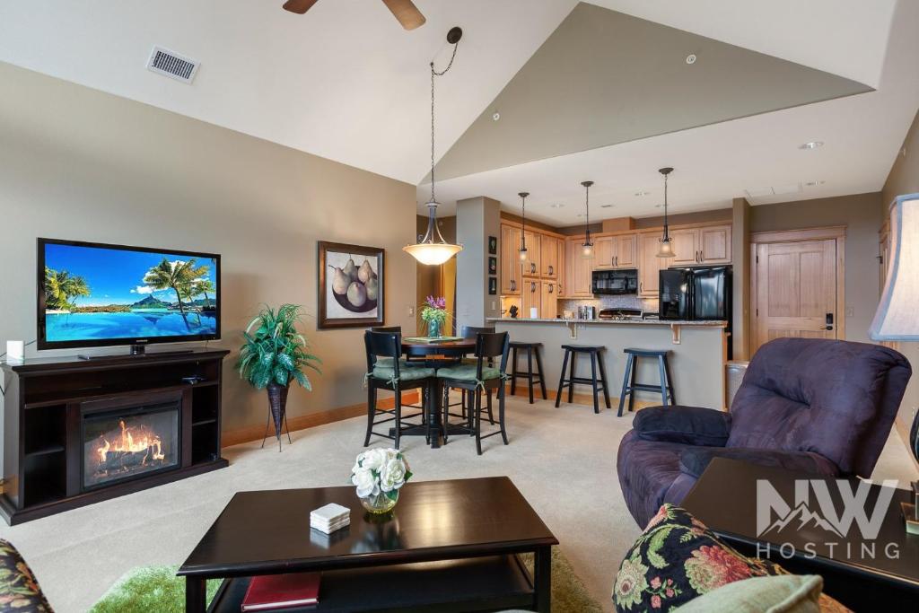 a living room with a couch and a fireplace at RC 309 Riverstone Village in Coeur d'Alene