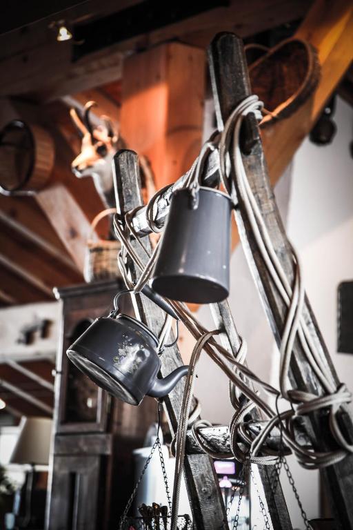 a group of bells hanging on a wall at Hôtel Le Refuge in Tignes