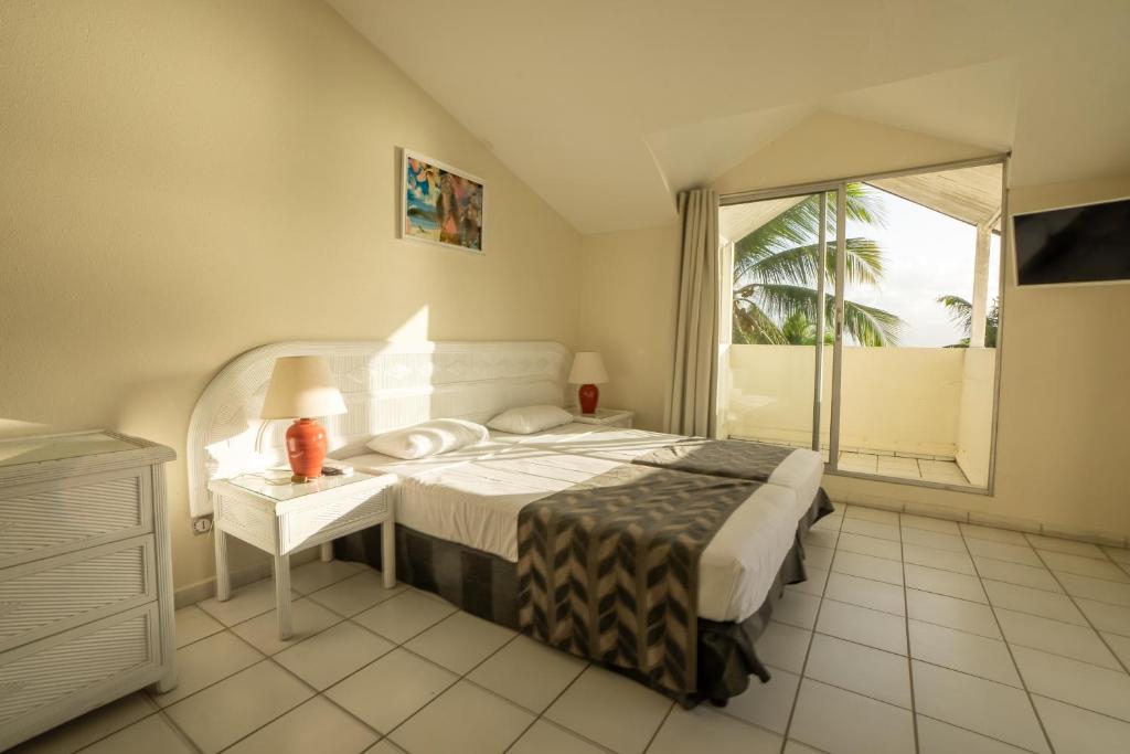 Uma cama ou camas num quarto em Canella Beach Hotel