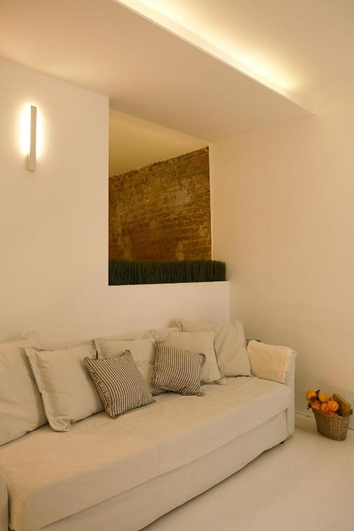 a white couch in a living room with a painting on the wall at La Chicca di Sant'Agata in Brescia