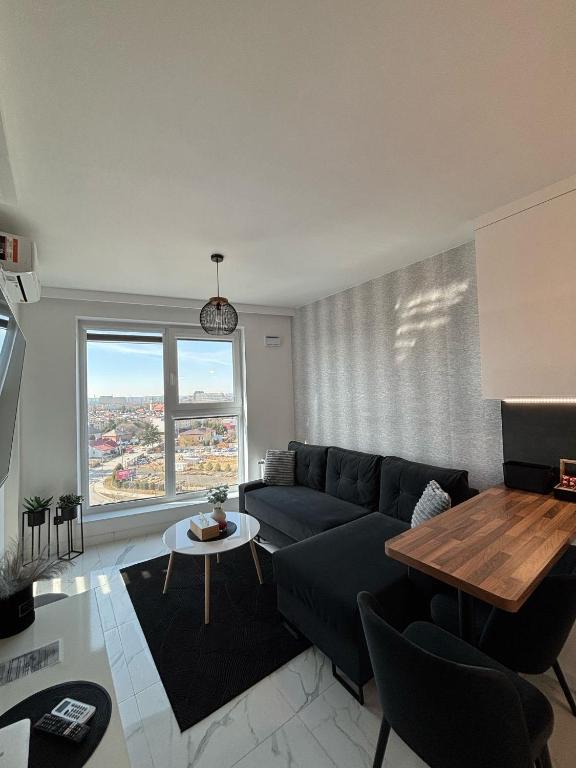 a living room with a blue couch and a table at ST55 Apartament in Rzeszów