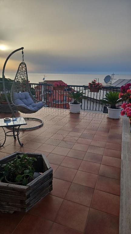a patio with a hammock and a table and aoitternessterness at Casa Vacanze Le terrazze in Castel di Tusa