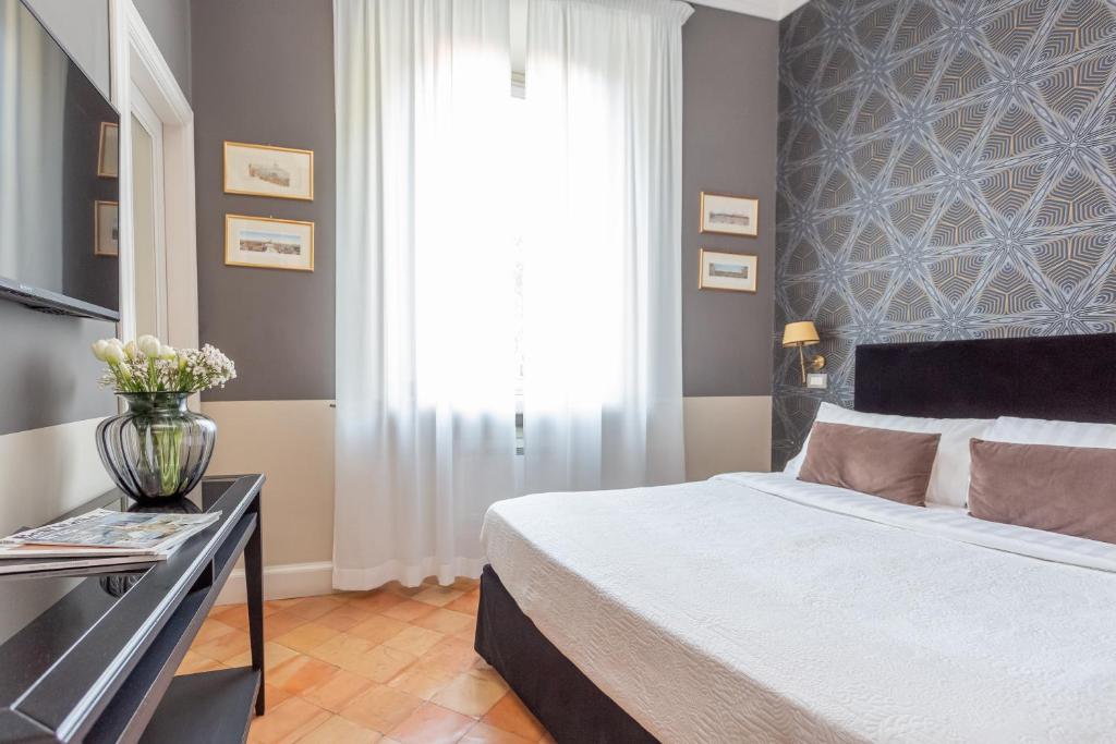 Postel nebo postele na pokoji v ubytování Hotel Parrasio