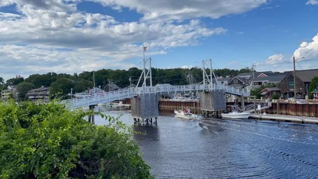 a bridge over a river with boats on the water at Footbridge Escape in Ogunquit