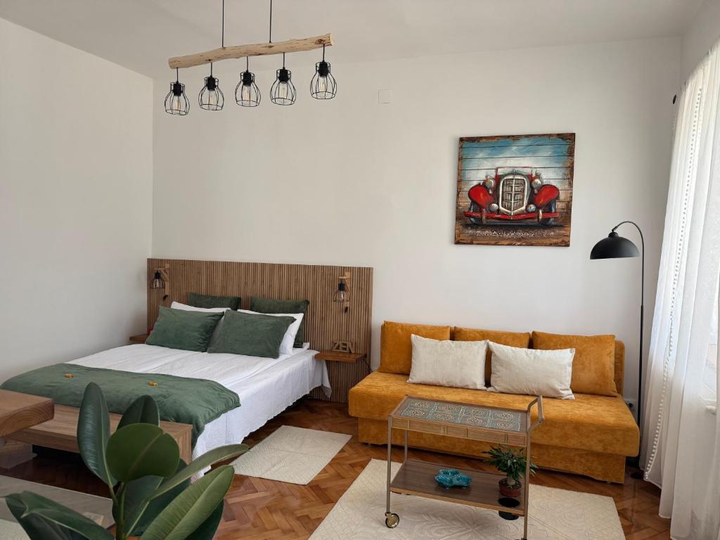 a bedroom with a bed and a couch at RetroHouse in Târgu-Mureş
