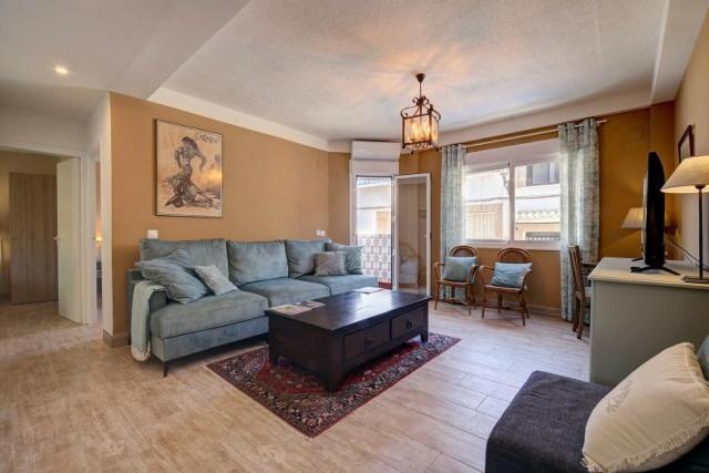 a living room with a couch and a table at Duquesa Marina - Manilva Beach Home in Manilva