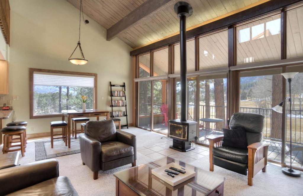 a living room with a couch and a fireplace at Tamarron PineCone 858 in Durango