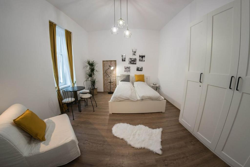 a living room with two beds and a couch at City Center Festival Apartment in Cluj-Napoca