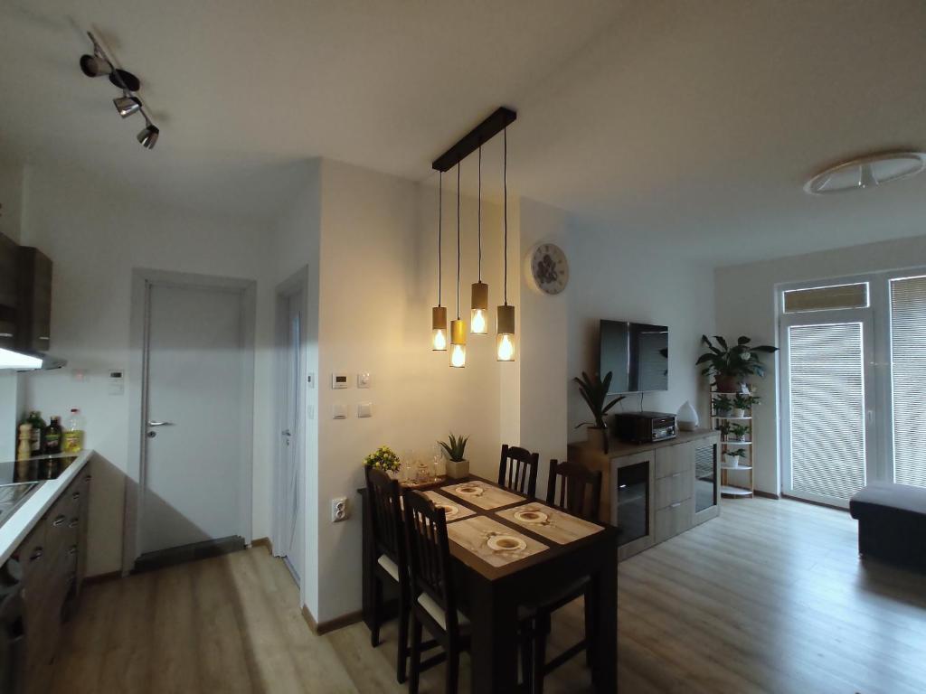 a kitchen and dining room with a table and chairs at Coffee Apartment on Sunny Day 6 Complex in Tŭnkovo