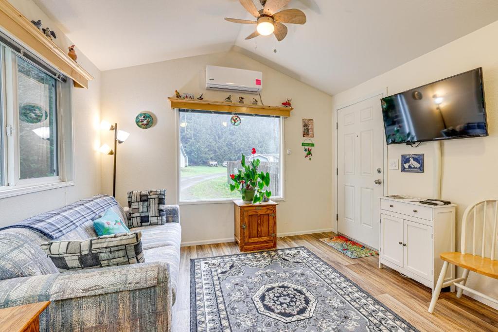 a living room with a couch and a tv at Remote Workers Welcome Tiny Home in Port Angeles! in Port Angeles