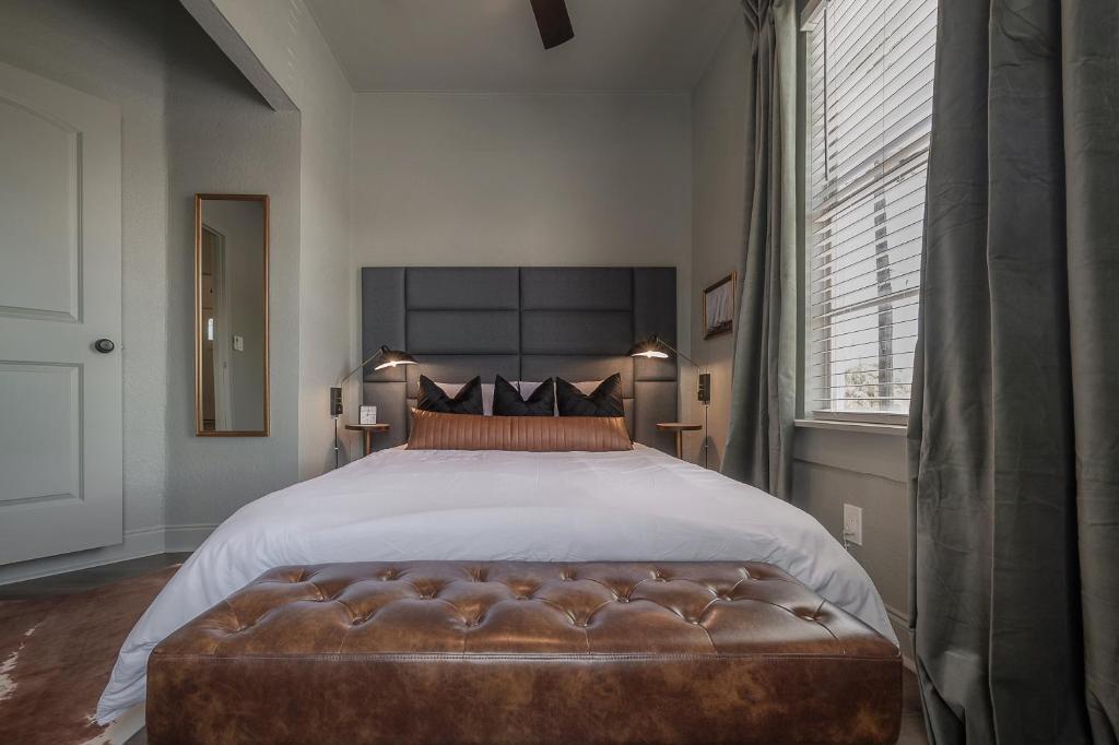 a bedroom with a large bed with a leather tufted foot board at Updated Condo in Heart of Tampa 1569 in Tampa